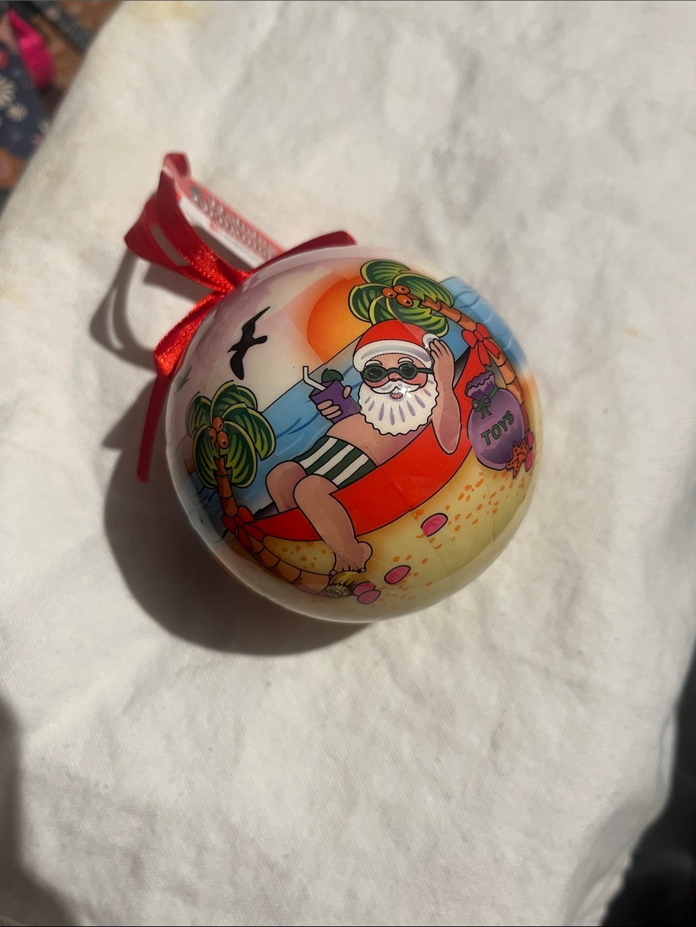 NWT Caribbean Cruising Santa Ornament with Red Ribbon